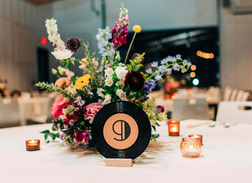 Floral arrangement on indoor reception table at Retreat 21 wedding venue near Columbus, Ohio